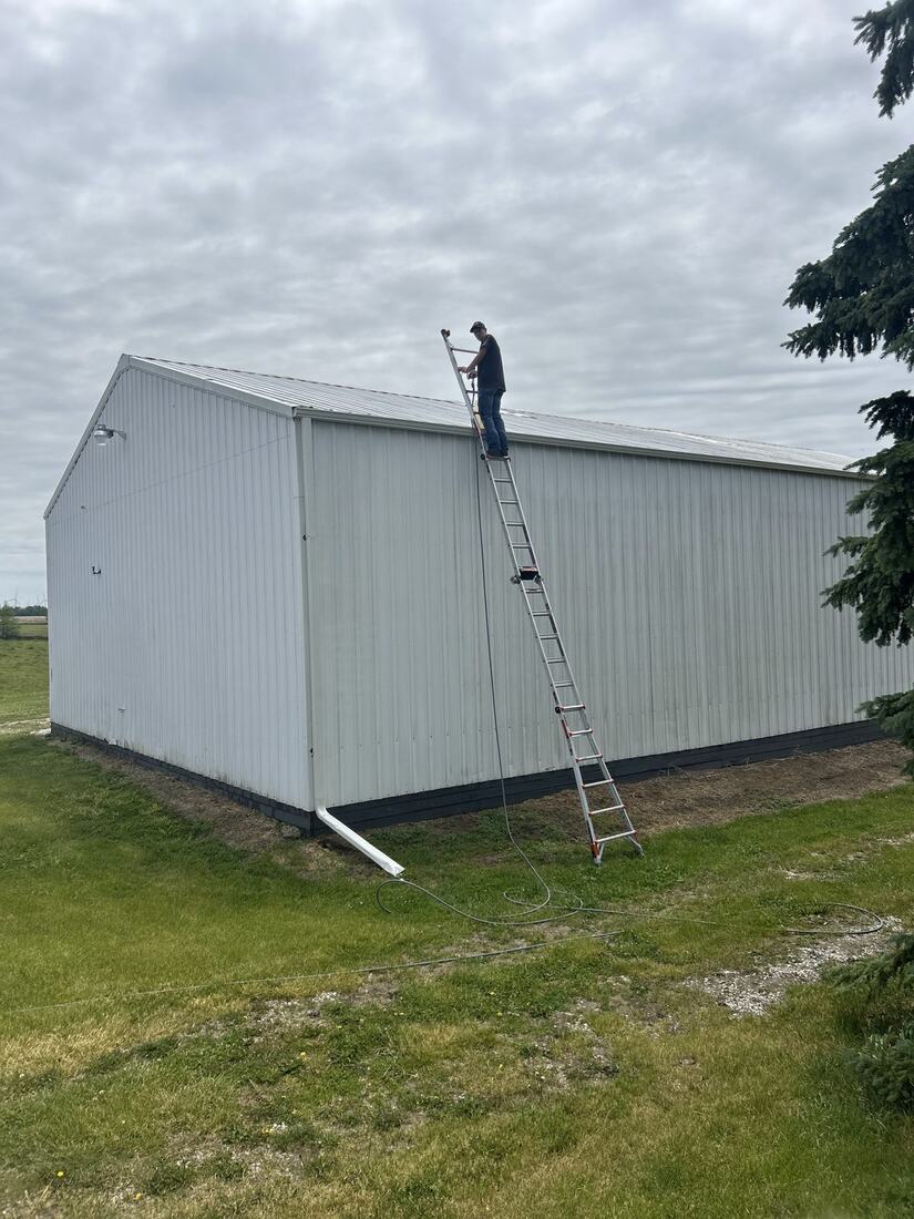 Washing a pole barn roofline