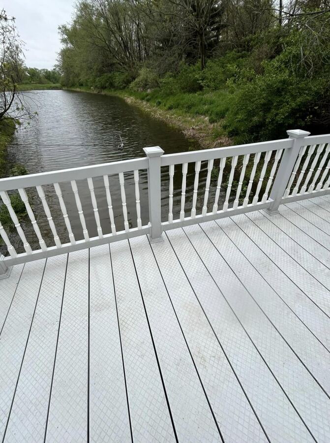 Composite deck and vinyl railing on the pond, after