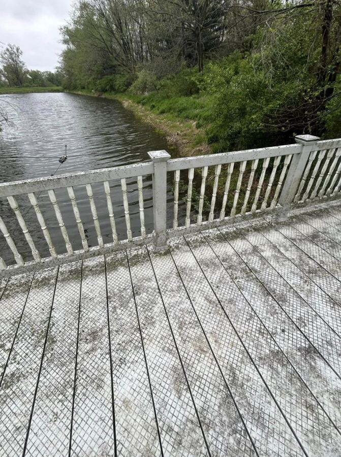 Composite deck and vinyl railing on the pond, before