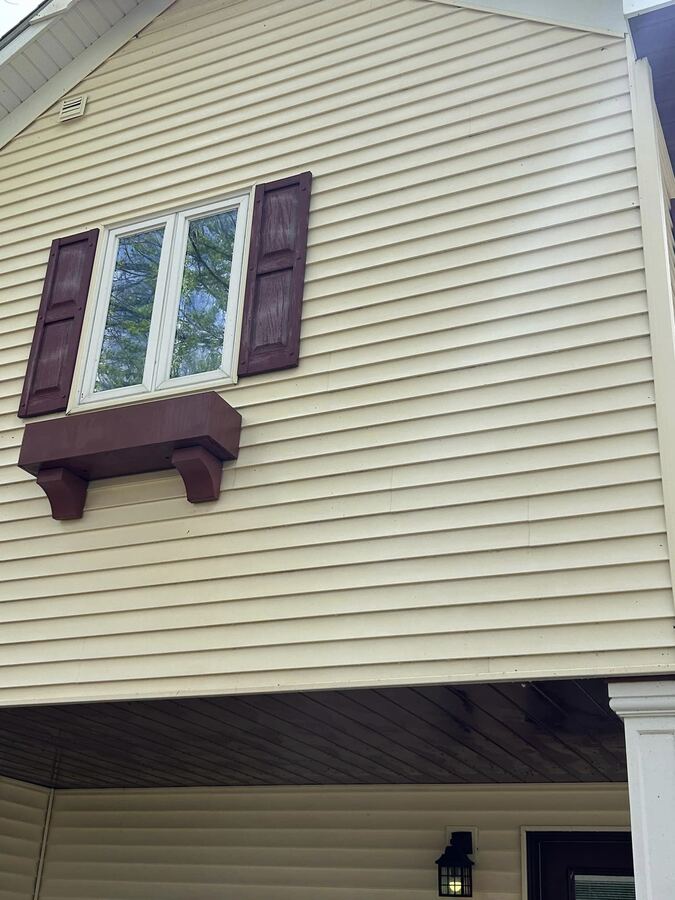 Vinyl gable with black mildew, washed, after