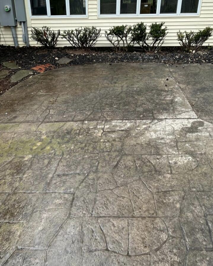 Stamped concrete patio: moss and grime removed, before